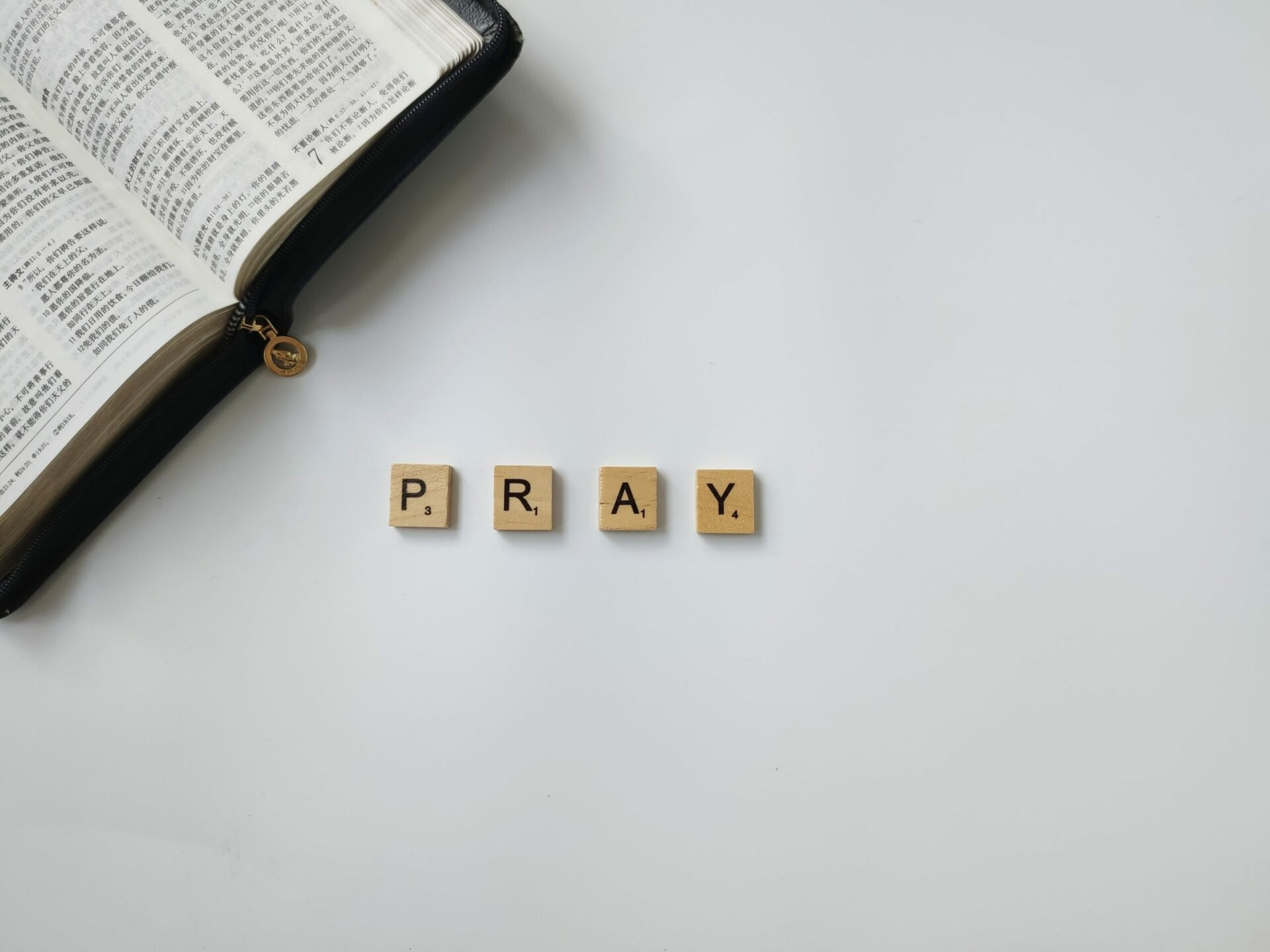 Pray tiles next to bible