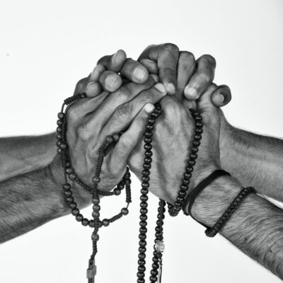 Hands and rosary beads
